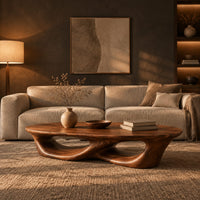 Low coffee table with an oval top and twin open loops in a dark living room at golden hour