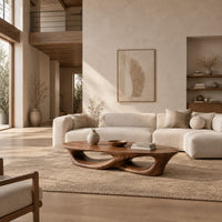 Low coffee table with an oval top and twin open loops in a bright open plan living room
