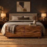 Low bench with four wavy grain front panels on short block feet in a dark bedroom at golden hour