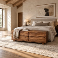 Low bench with four wavy grain front panels on short block feet in a bright open plan bedroom