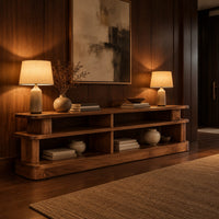 Low stepped open shelf console table with a raised section at one end in an evening entryway with walnut wall paneling