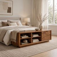 Low storage bench with four open cubbies and a closed wood panel in a Scandinavian bedroom with white walls