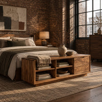 Low storage bench with four open cubbies and a closed wood panel in an industrial loft bedroom with exposed brick