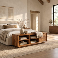 Low storage bench with four open cubbies and a closed wood panel in a bright open plan bedroom