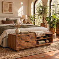 Low bench with two drawers, an open shelf cubby and a seat pad in a bright bedroom with arched windows and plants