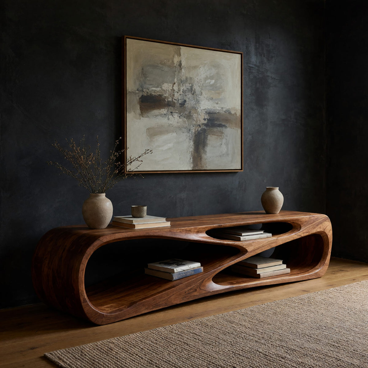 Low TV console with a carved crossing hollow in a dark studio against a charcoal wall