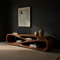 Low TV console with a carved crossing hollow, three-quarter view showing the grain