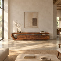 Low tv stand with a looped top over four flat front panels in a bright open plan living room