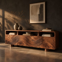 Low wood tv stand with a carved wave front and open top compartments, three-quarter view showing the grain