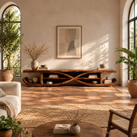 Low tv stand with crossed curves and upturned sled ends in a bright living room with arched windows and plants
