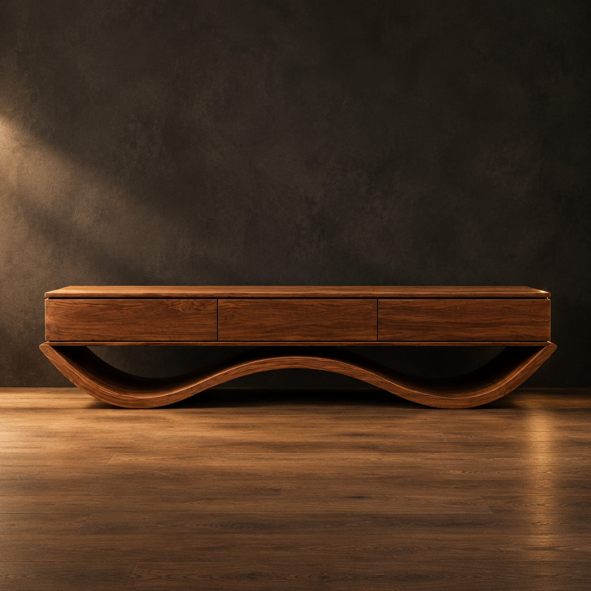 Low tv stand with three front panels on a wave shaped base in a dark studio against a charcoal plaster wall