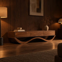 Low tv stand with three front panels on a wave shaped base in an evening living room with walnut wall paneling