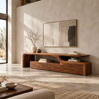 Low tv stand with a sweeping wave top and a four panel front in a bright open plan living room