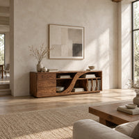 Low tv stand with three drawers and a swooping divider beside vertical slots in a bright open plan living room