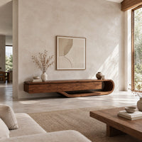 Low tv stand with a three panel front and a sweeping curved loop base in a bright open plan living room
