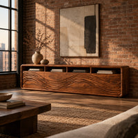 Low tv stand with four open cubbies above wave carved front panels in an industrial loft living room with exposed brick