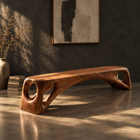 Low solid wood bench with an arched underside and open cutouts at each end, three-quarter view showing the grain