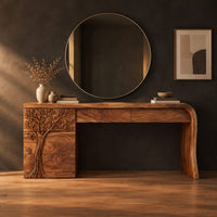 Makeup vanity with a carved tree pedestal and a sweeping slab leg in a dark studio against a charcoal plaster wall