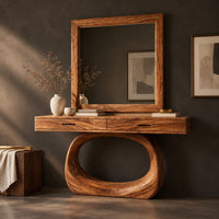 Corner detail of makeup vanity with a wide top and an open oval loop base beside wood, brass and linen samples
