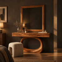 Makeup vanity with a wide top and an open oval loop base in a dark bedroom at golden hour