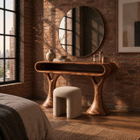 Makeup vanity with a pill shaped open shelf top and flared pedestal legs in an industrial loft bedroom with exposed brick