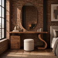 Makeup vanity with an s curve pedestal and a three drawer cabinet in an industrial loft bedroom with exposed brick
