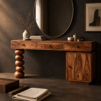 Corner detail of makeup vanity with three drawers a stacked bead leg and a side cabinet beside wood, brass and linen samples