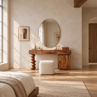 Makeup vanity with three drawers a stacked bead leg and a side cabinet in a bright open plan bedroom