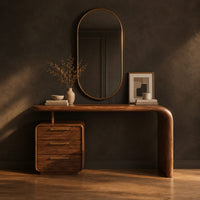 Makeup vanity with a waterfall end and a three drawer cabinet in a dark studio against a charcoal plaster wall
