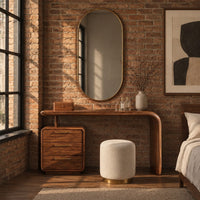 Makeup vanity with a waterfall end and a three drawer cabinet in an industrial loft bedroom with exposed brick