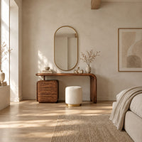 Makeup vanity with a waterfall end and a three drawer cabinet in a bright open plan bedroom
