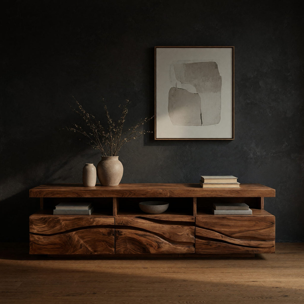 Media cabinet with open cubbies above carved wave drawers in a dark studio against a charcoal wall