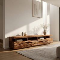 Media cabinet with open cubbies above carved wave drawers in a bright modern living room