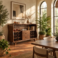 Mid century bar cabinet with a curved frame, square cubbies and two drawers in a bright dining room with arched windows and plants