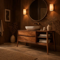 Mid century wood vanity with two drawers and open side shelves on tapered legs in an evening bathroom with walnut wall paneling
