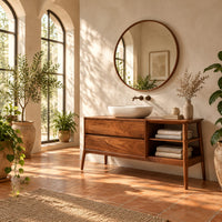 Mid century wood vanity with two drawers and open side shelves on tapered legs in a bright bathroom with arched windows and plants