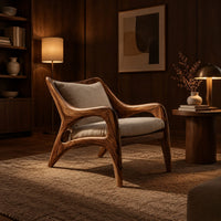 Wooden armchair with sweeping sculpted arms and splayed legs in an evening living room with walnut wall paneling