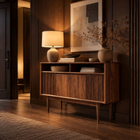 Mid century console table with fluted front and tapered legs in an evening entryway with walnut wall paneling