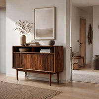 Mid century console table with fluted front and tapered legs in a Scandinavian entryway with white walls