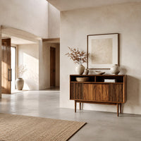 Mid century console table with fluted front and tapered legs in a bright open plan entryway