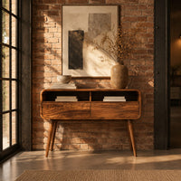 Mid century wooden console table with open compartments above two front panels in an industrial loft entryway with exposed brick