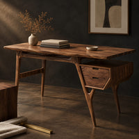 Corner detail of mid century desk with tapered legs and a wedge shaped two drawer box beside wood, brass and linen samples
