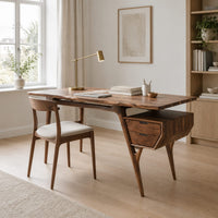 Mid century desk with tapered legs and a wedge shaped two drawer box in a Scandinavian home office with white walls