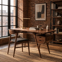 Mid century desk with tapered legs and a wedge shaped two drawer box in an industrial loft home office with exposed brick