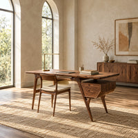 Mid century desk with tapered legs and a wedge shaped two drawer box in a bright open plan home office