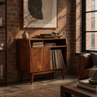 Mid century record player stand with one flat door and tapered legs in an industrial loft living room with exposed brick