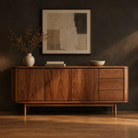 Mid century sideboard with three drawers and tapered legs in a dark studio against a charcoal plaster wall