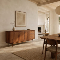 Mid century sideboard with three drawers and tapered legs in a bright open plan dining room