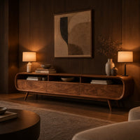 Low tv stand with pill shaped ends, three open cubbies and slim tapered legs in an evening living room with walnut wall paneling