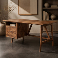 Corner detail of mid century desk with a drawer pedestal, open cubby and angled trestle legs beside wood, brass and linen samples